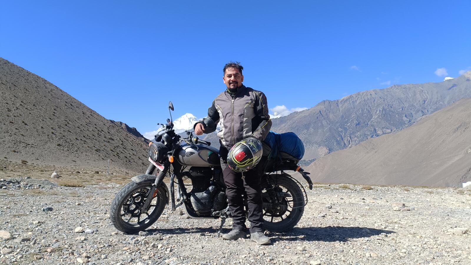 A Royal Enfield rider paused in the high Himalaya
